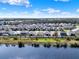 Scenic aerial view of homes with beautiful lake and highlighting the community's beautiful landscaping at 1204 Pando Loop, Orlando, FL 32824