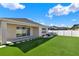 Inviting backyard with manicured lawn, a water feature, stepping stones, and covered patio at 1204 Pando Loop, Orlando, FL 32824