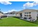 Backyard featuring manicured lawn, water feature, stepping stones, and a hot tub at 1204 Pando Loop, Orlando, FL 32824