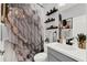 Well-appointed bathroom with decorative shower curtain and shelving at 1204 Pando Loop, Orlando, FL 32824