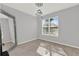 Bright bedroom with a large window, neutral walls, modern light fixture, and a full-length mirror at 1204 Pando Loop, Orlando, FL 32824