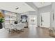 Bright and airy dining area with a contemporary white table, elegant lighting, and tile flooring at 1204 Pando Loop, Orlando, FL 32824