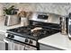 Kitchen with a gas range and stainless steel appliances and a decorative backsplash at 1204 Pando Loop, Orlando, FL 32824