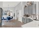 Bright and airy kitchen with gray cabinets, stainless appliances, quartz counters, and adjacent dining area at 1204 Pando Loop, Orlando, FL 32824