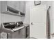 Laundry room with modern washer and dryer, storage cabinets, and a hanging rack at 1204 Pando Loop, Orlando, FL 32824