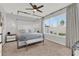 Spacious main bedroom with a four-poster bed, modern lighting, and large windows at 1204 Pando Loop, Orlando, FL 32824