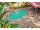 Aerial view of a beautiful pool with brick pavers, lush greenery, and a covered patio at 122 N Hyer Ave, Orlando, FL 32801