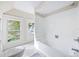 Bathroom featuring a white tiled shower and soaking tub, with a pedestal sink at 122 N Hyer Ave, Orlando, FL 32801