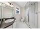 Bright bathroom featuring a glass enclosed shower and granite countertop vanity at 122 N Hyer Ave, Orlando, FL 32801