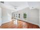 Sunlit bedroom featuring hardwood floors and a mirrored closet at 122 N Hyer Ave, Orlando, FL 32801