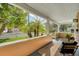 Covered front porch with wood ceiling, seating, and view of the front yard at 122 N Hyer Ave, Orlando, FL 32801