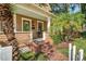 Inviting front porch with brick steps, decorated glass front door, and small seating area at 122 N Hyer Ave, Orlando, FL 32801