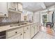 Well-lit kitchen with granite countertops, stainless steel sink, and views to a front room and breakfast nook at 122 N Hyer Ave, Orlando, FL 32801