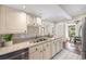 Bright kitchen with granite countertops, stainless steel appliances, and white cabinetry at 122 N Hyer Ave, Orlando, FL 32801