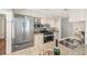 Modern kitchen featuring stainless steel appliances, granite countertops, and white cabinetry at 122 N Hyer Ave, Orlando, FL 32801