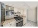 Modern kitchen featuring stainless steel appliances, granite countertops, and white cabinets at 122 N Hyer Ave, Orlando, FL 32801