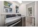 Well-lit laundry room featuring new washer and dryer units with a utility sink at 122 N Hyer Ave, Orlando, FL 32801