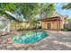 Sparkling pool with brick patio and a covered patio, creating an ideal backyard oasis at 122 N Hyer Ave, Orlando, FL 32801