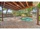 Inviting backyard pool with brick pavers and a covered patio, perfect for outdoor relaxation at 122 N Hyer Ave, Orlando, FL 32801