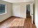 This bedroom features laminate wood flooring, a window, and a built-in closet at 13842 Belvin Ct, Orlando, FL 32826