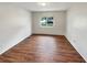 Clean bedroom featuring hardwood floors and a bright window with natural light at 13842 Belvin Ct, Orlando, FL 32826