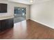 Dining room with dark wood-look floors adjacent to sliding glass doors to the sunroom and kitchen at 13842 Belvin Ct, Orlando, FL 32826