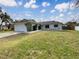 Attractive home featuring a large front yard, two-car garage, and neat landscaping at 13842 Belvin Ct, Orlando, FL 32826