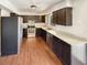 Well-equipped kitchen featuring stainless steel appliances, laminate countertops, and dark cabinets at 13842 Belvin Ct, Orlando, FL 32826