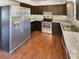 Modern kitchen featuring stainless steel appliances, dark cabinetry, and durable countertops at 13842 Belvin Ct, Orlando, FL 32826