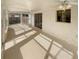 Bright sunroom featuring textured walls, ceiling fans, and sliding glass doors to the outside at 13842 Belvin Ct, Orlando, FL 32826