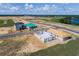 Aerial view of new homes in a community under construction with a lake nearby at 16863 Muskgrass Dr, Winter Garden, FL 34787