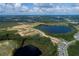 An aerial view of a Primary-planned community with lake views and newly built homes in development at 16863 Muskgrass Dr, Winter Garden, FL 34787