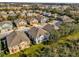 Picturesque aerial view of a residential community with vibrant homes, mature trees, and a tranquil pond at 1710 San Jacinto Cir # 1710, Sanford, FL 32771