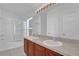 Bathroom featuring double sinks, a large mirror, and walk-in shower at 1710 San Jacinto Cir # 1710, Sanford, FL 32771