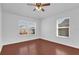 Bright bedroom with wood floors and ample natural light from two windows at 1710 San Jacinto Cir # 1710, Sanford, FL 32771