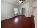 Bedroom with rich-toned hardwood floors, ceiling fan, and walk-in closet at 1710 San Jacinto Cir # 1710, Sanford, FL 32771