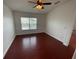 The bedroom features wood floors and a ceiling fan at 1710 San Jacinto Cir # 1710, Sanford, FL 32771