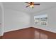 Well-lit bedroom featuring wood floors, a ceiling fan, and a large window at 1710 San Jacinto Cir # 1710, Sanford, FL 32771