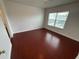 Bedroom with wood floors and a single window at 1710 San Jacinto Cir # 1710, Sanford, FL 32771