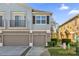 Two-story townhome featuring individual garages, a balcony and muted blue and gray color scheme at 1710 San Jacinto Cir # 1710, Sanford, FL 32771