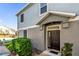 Two-story townhome with a dark front door, gray siding, and neatly trimmed bushes at 1710 San Jacinto Cir # 1710, Sanford, FL 32771