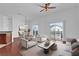 Bright living room featuring hardwood floors, white walls, stylish furniture, and sliding doors to balcony at 1710 San Jacinto Cir # 1710, Sanford, FL 32771