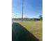 View of backyard with water feature and trees from a grassy lawn at 1926 Golden Beak Dr, Eagle Lake, FL 33839