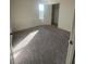 Bedroom featuring a neutral carpet, white walls, closet, and natural light at 1926 Golden Beak Dr, Eagle Lake, FL 33839