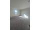 Bedroom featuring neutral carpet, white walls, and a window with natural light at 1926 Golden Beak Dr, Eagle Lake, FL 33839