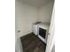 Laundry room with new white washer and dryer on a wood floor at 1926 Golden Beak Dr, Eagle Lake, FL 33839