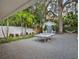 Backyard featuring a ping pong table, mature trees, and a tranquil garden area at 1932 Temple Dr, Winter Park, FL 32789