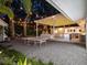 Private backyard retreat with ping pong table, cozy lounge area, and a covered patio illuminated with string lights at 1932 Temple Dr, Winter Park, FL 32789