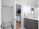 Contemporary bathroom with gray vanity, modern fixtures, and a door that opens to a bedroom at 1932 Temple Dr, Winter Park, FL 32789