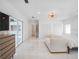 Bright bedroom featuring white marble floors, a modern light fixture, and ample natural light at 1932 Temple Dr, Winter Park, FL 32789